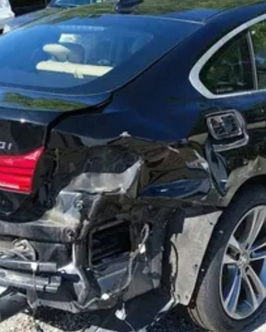 BMW 440i with crushed rear end, photographed at auction